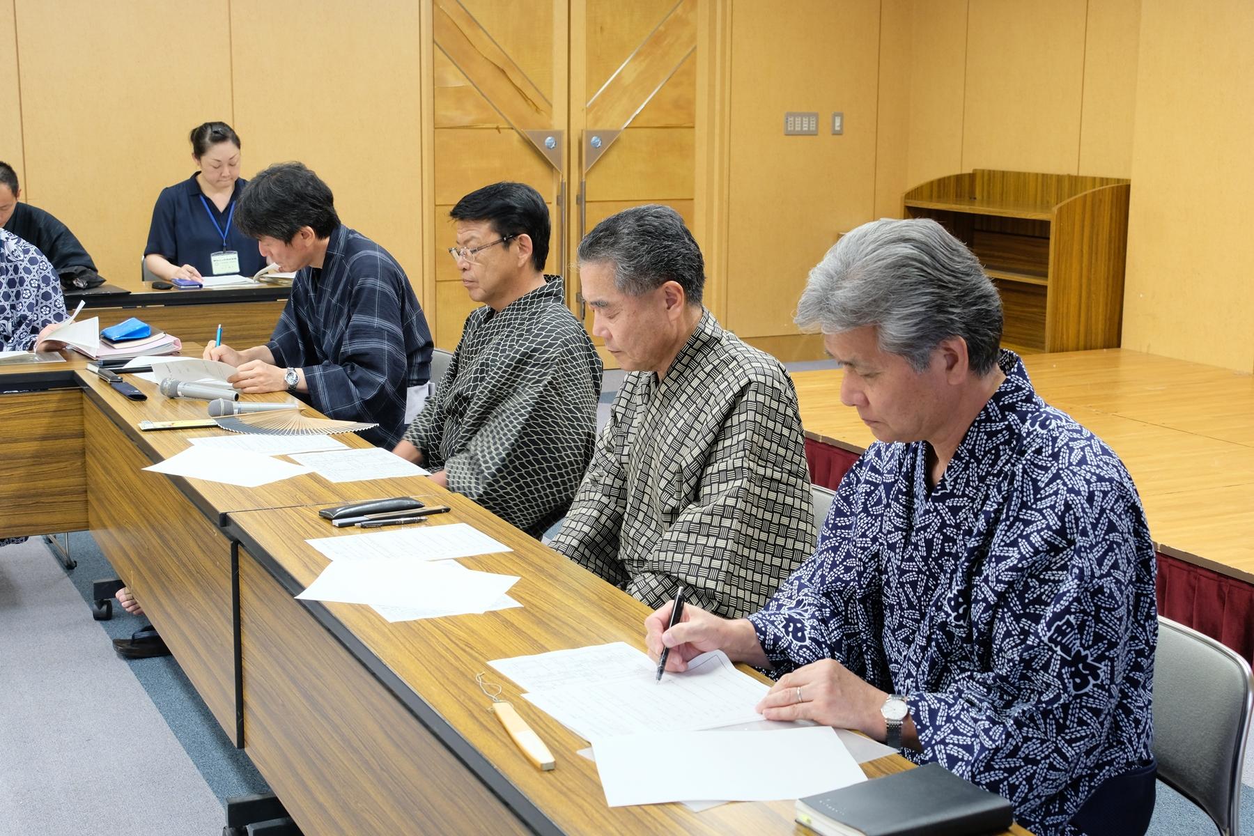 会議をしている浴衣姿の職員の写真